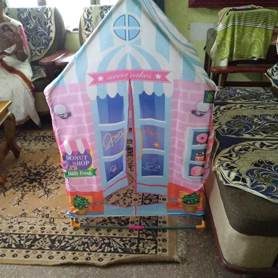 Children's playhouse with colorful design on a carpeted floor