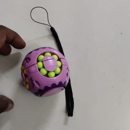 Colorful ball with a black strap on a white surface