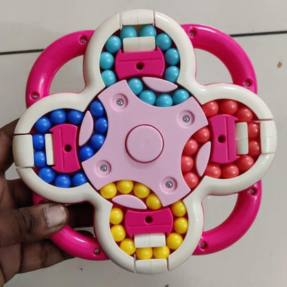 Colorful plastic toy with beads held by a hand on a light gray background