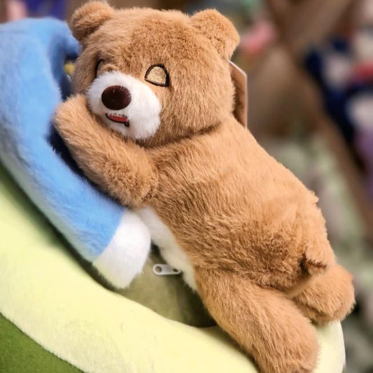 Plush teddy bear toy on a colorful surface with a blurred background