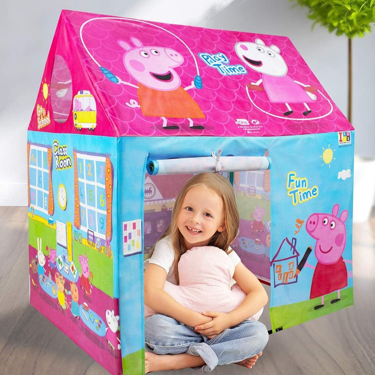 Child playing inside a Peppa Pig-themed play tent with a girl sitting inside.